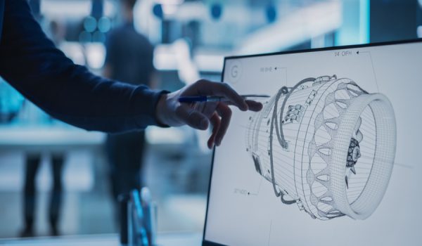 Close Up of a Desktop Computer Monitor Screen with 3D CAD Software with Prototype Jet Engine Project. Specialist Discussing Work, His Hand Visible In Front of the Screen.