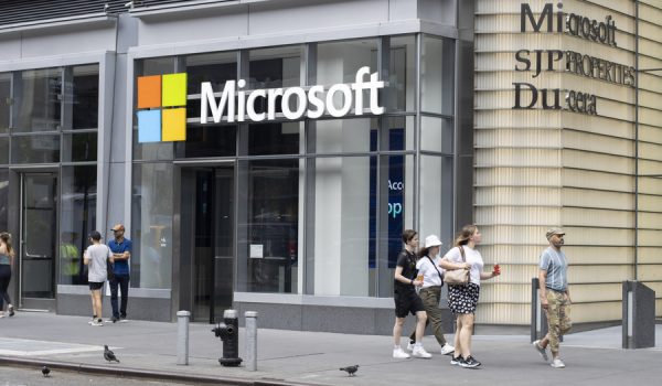 New York, NY, USA - July 5, 2022: People walk past the entrance to the Microsoft office in Eleven Times Square in Midtown Manhattan, New York City. Microsoft Corporation is an American multinational technology company.