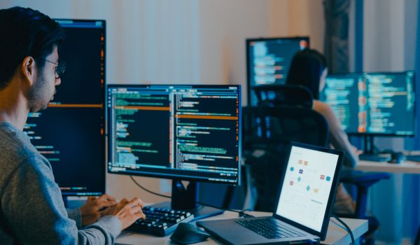 Group Adult Asia male, female freelance typing write prompt AI bot IT app smart program nomad, video game, terminal with coding language, designer, big data center on desktop computer in night office.