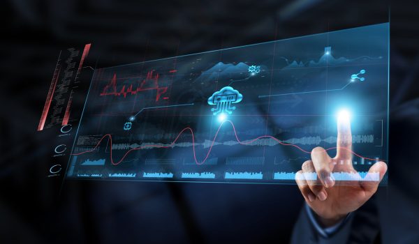 Cloud Computing: Businessman analyzes data strategy with graph on digital screen. Scalability, data storage, remote access, virtualization, collaboration, security, cost-efficiency.