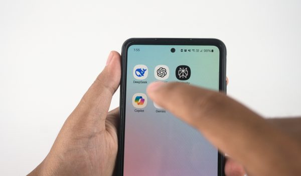 Sleman, Indonesia - February 04, 2025: Person's hand using a smartphone to select an Aetificial Intelligence Apps icon on its touchscreen. Such as Deepseek, ChatGPT, Copilot, Gemini, and Perplexity