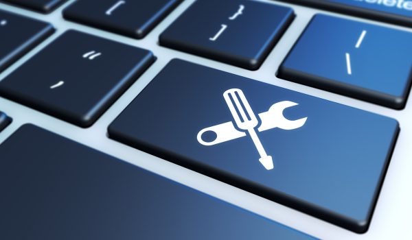 Computer service and assistance concept with work tool icon on a laptop keyboard 3D illustration.